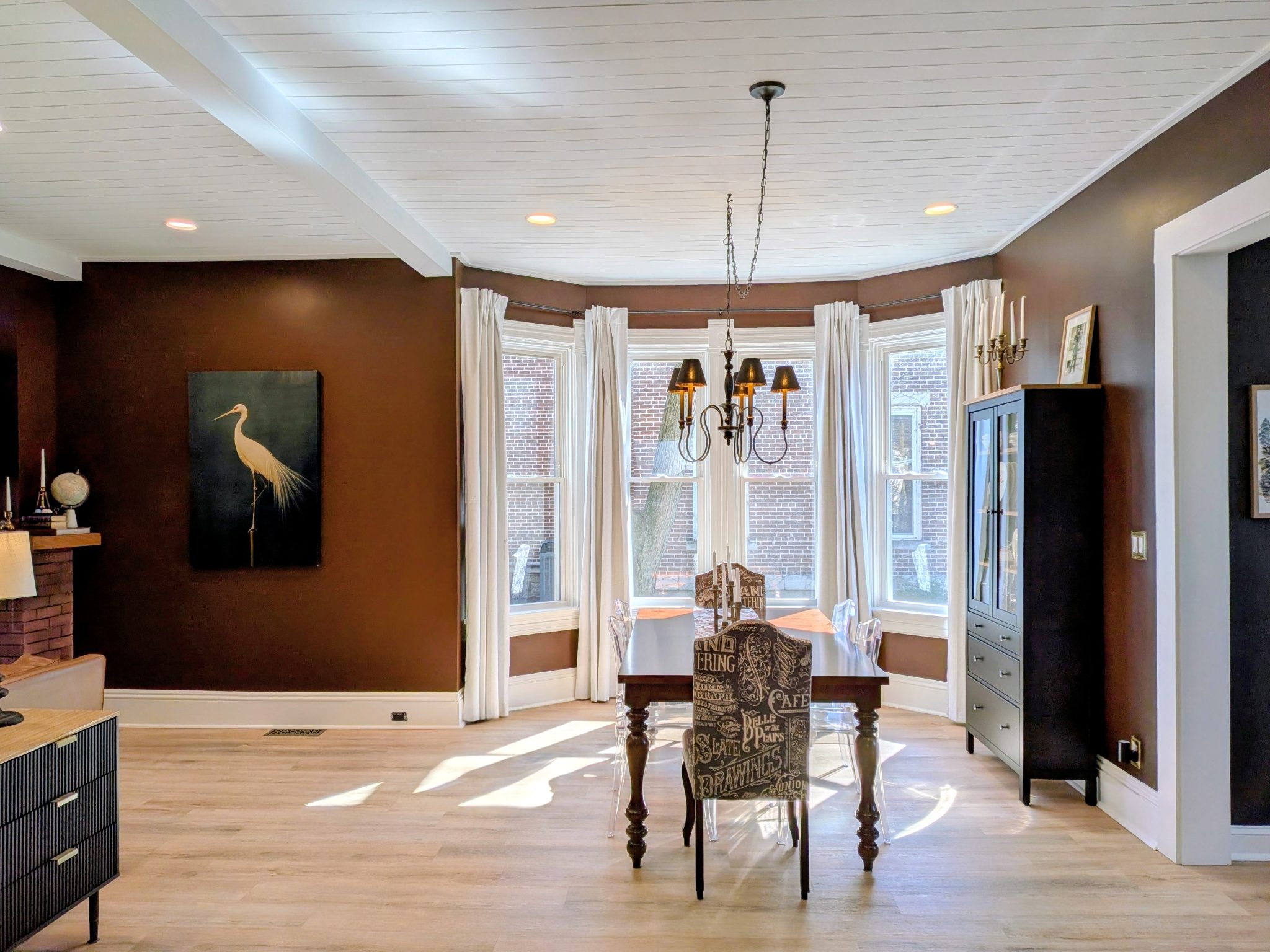 Living room, dining room walls painted in Rojo Marron by Sherwin Williams. A deep rich red/brown tone.